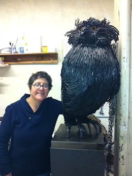 Artist with Owl Sculpture