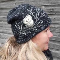 Hand knitted beanie hat with embroidery owl