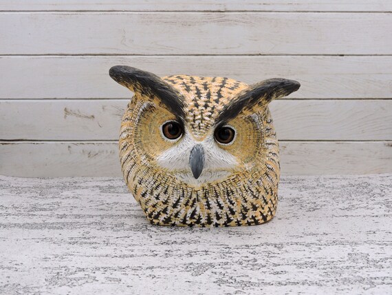 Eagle owl, a wooden sculpture of an owl head.