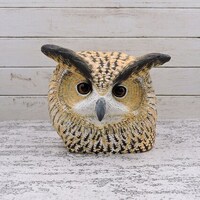 Eagle owl, a wooden sculpture of an owl head.