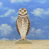 An owl sculpture, a burrowing owl, a wooden owl.