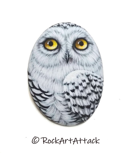 Snowy owl hand painted on flat pebble