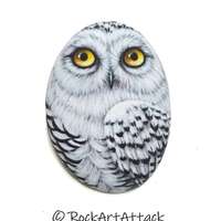 Snowy owl hand painted on flat pebble